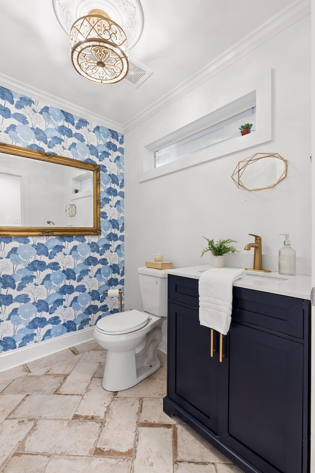 bathroom with vanity, toilet, and crown molding