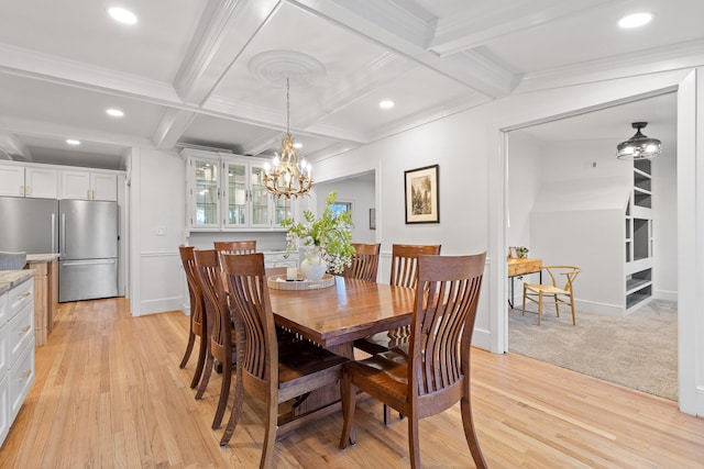 dining space featuring a notable chandelier, coffered ceiling, ornamental molding, beam ceiling, and light hardwood / wood-style flooring