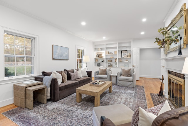 living room with ornamental molding and hardwood / wood-style floors