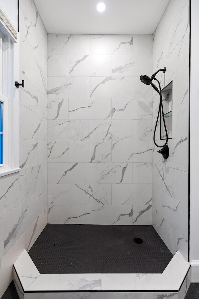 bathroom with tiled shower