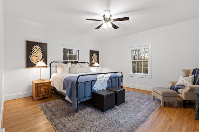 bedroom with light hardwood / wood-style floors and ceiling fan