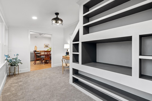 hall with carpet flooring and crown molding