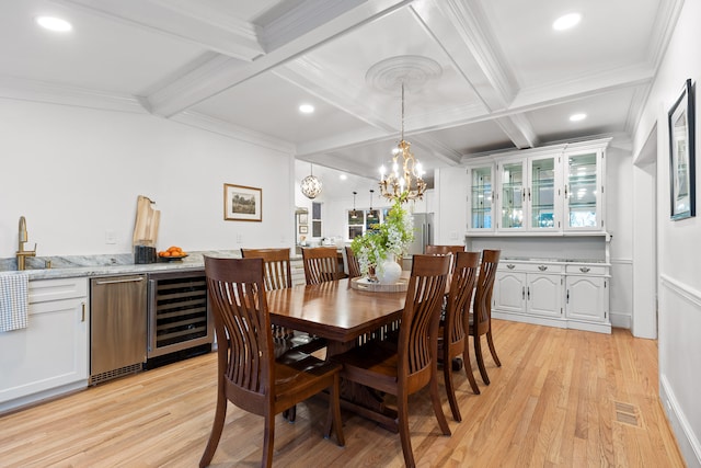 dining area featuring wine cooler, beam ceiling, light hardwood / wood-style flooring, crown molding, and coffered ceiling