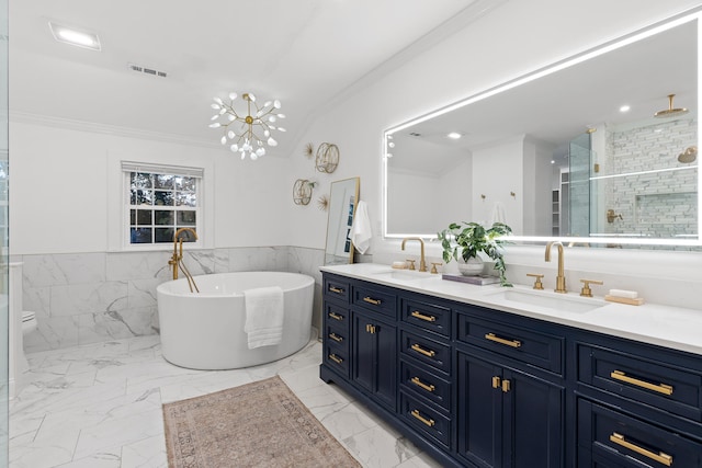 bathroom featuring tile walls, ornamental molding, vanity, and independent shower and bath