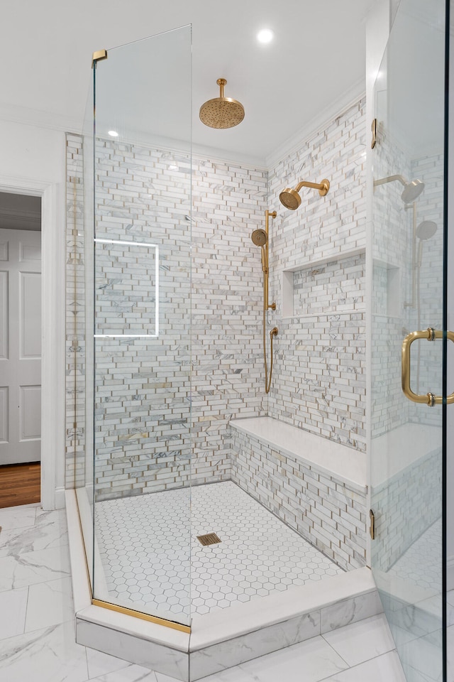 bathroom with ornamental molding and a shower with door