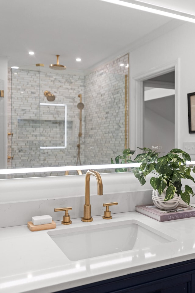 bathroom featuring sink and a tile shower