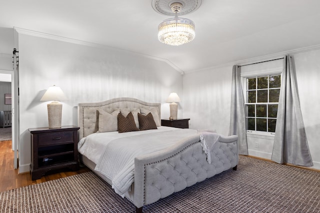 bedroom featuring dark hardwood / wood-style flooring, lofted ceiling, an inviting chandelier, and crown molding