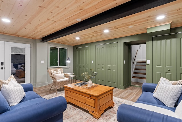 living room featuring light wood-type flooring, wooden ceiling, and beamed ceiling