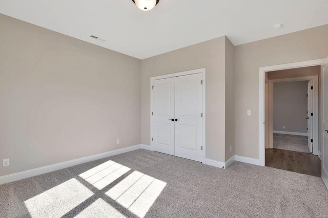 unfurnished bedroom with carpet floors and a closet