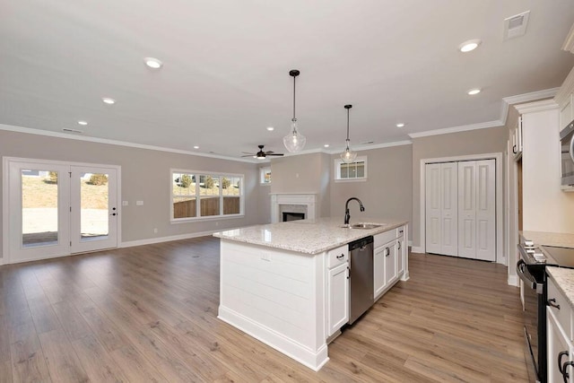 kitchen with white cabinetry, pendant lighting, a kitchen island with sink, and appliances with stainless steel finishes