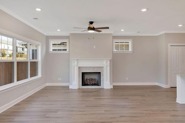 unfurnished living room with ornamental molding, ceiling fan, and light hardwood / wood-style floors