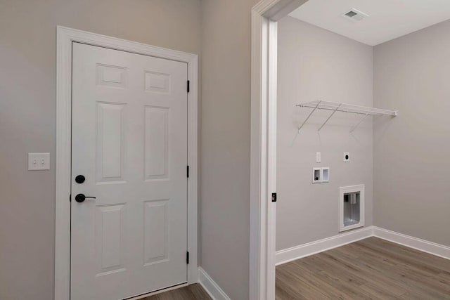 laundry room with electric dryer hookup, hookup for a washing machine, and wood-type flooring