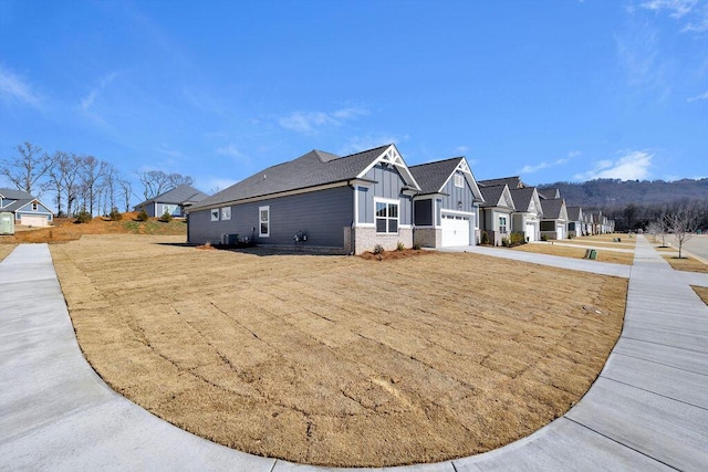 view of side of property with a garage and a yard