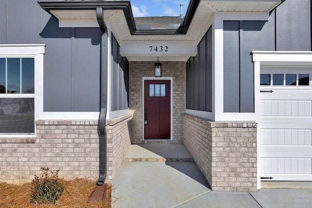 doorway to property with a garage