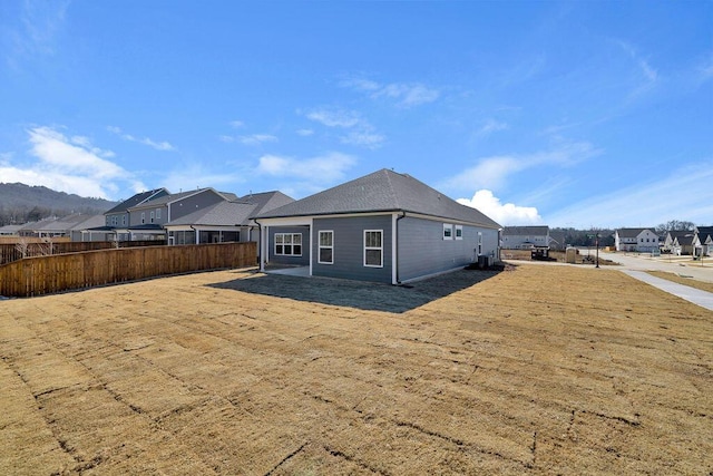 rear view of property with a yard