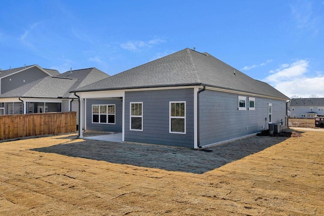 back of house featuring central AC unit, a yard, and a patio