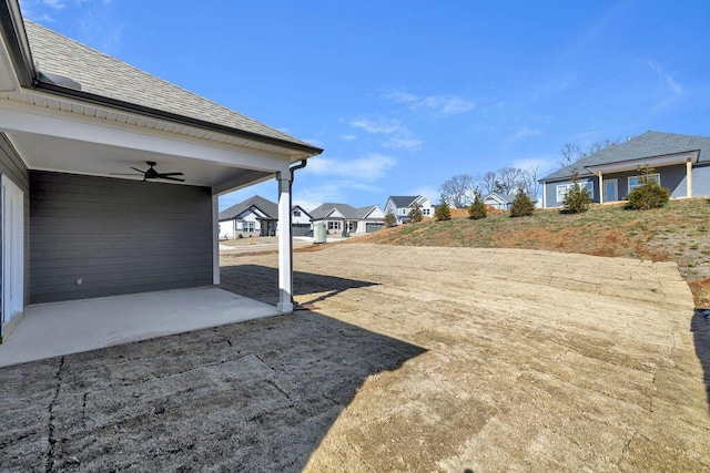 view of yard featuring a patio and ceiling fan