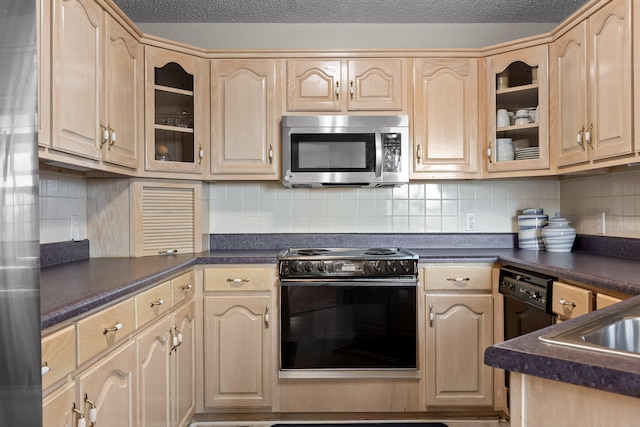 kitchen featuring stainless steel microwave, black electric range oven, dark countertops, and glass insert cabinets