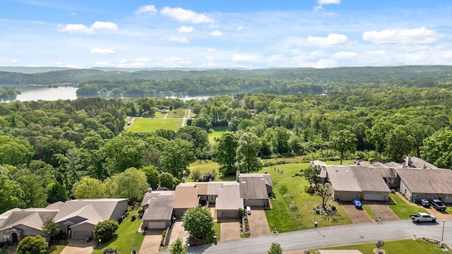 drone / aerial view featuring a residential view, a view of trees, and a water view