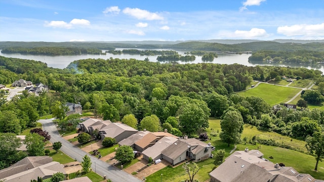 bird's eye view with a water view, a view of trees, and a residential view