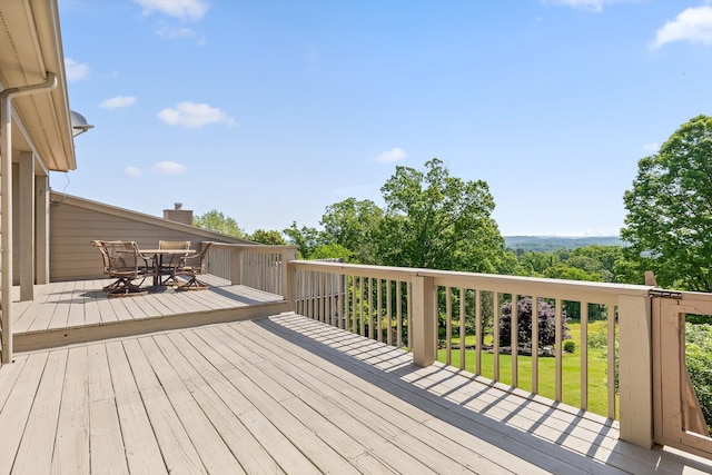 wooden terrace with outdoor dining area