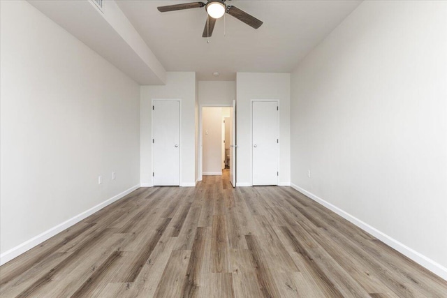 unfurnished bedroom featuring light wood-type flooring and ceiling fan