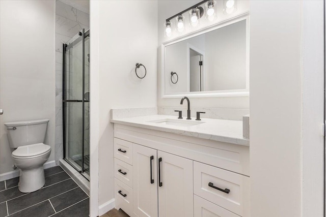 bathroom featuring tile patterned flooring, vanity, toilet, and a shower with door