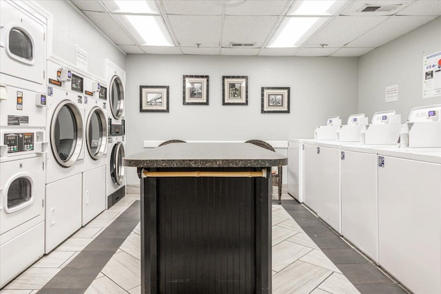 clothes washing area featuring stacked washer / drying machine and washing machine and dryer