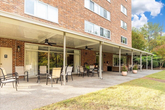 view of property's community with a yard and a patio area