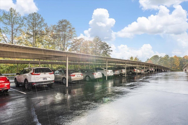 view of car parking with a water view and a carport