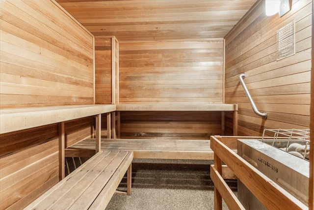 view of sauna / steam room with wooden walls and wood ceiling