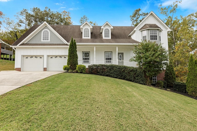 view of front of house featuring a front lawn, a porch, and a garage