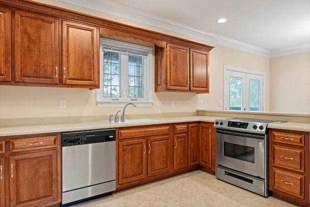 kitchen featuring stainless steel appliances, crown molding, a healthy amount of sunlight, and sink