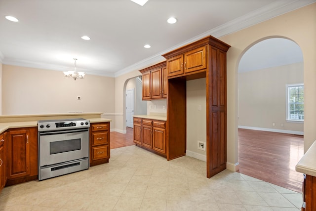 kitchen with an inviting chandelier, hanging light fixtures, stainless steel electric range, and ornamental molding