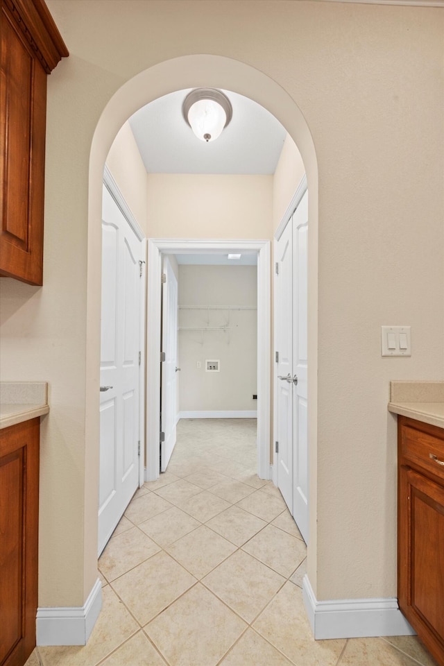 corridor featuring light tile patterned floors