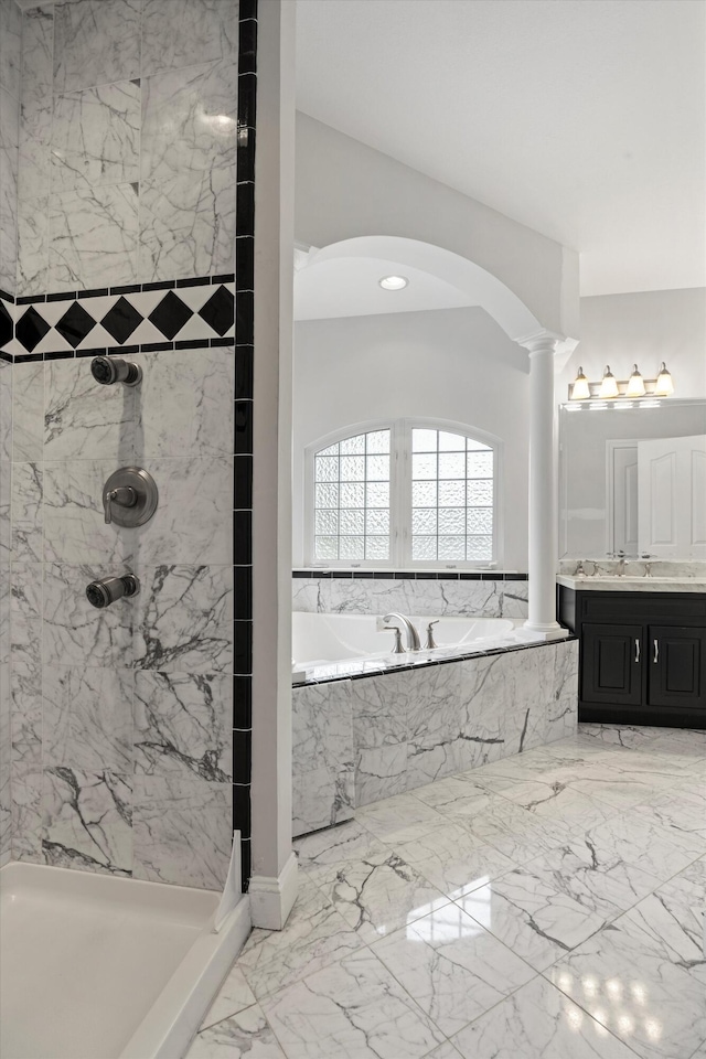 bathroom with vanity, ornate columns, and shower with separate bathtub