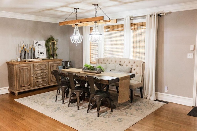 dining area with dark hardwood / wood-style flooring and crown molding