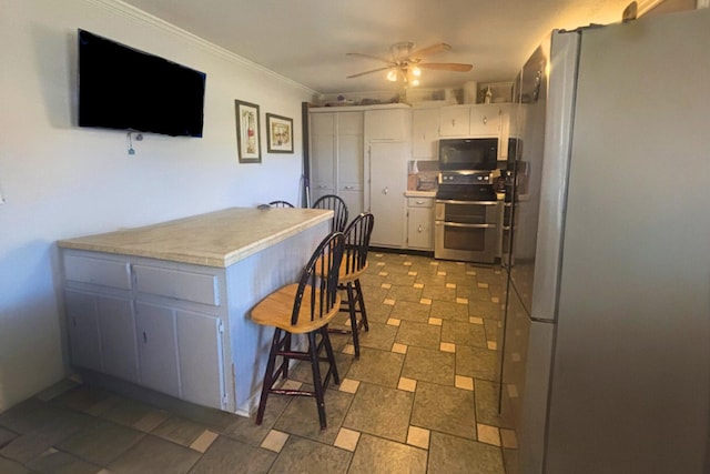 kitchen with ceiling fan, stainless steel appliances, a peninsula, light countertops, and ornamental molding