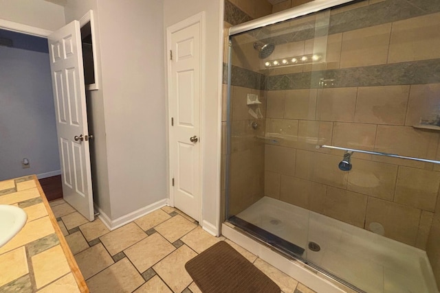 full bathroom with a stall shower and baseboards