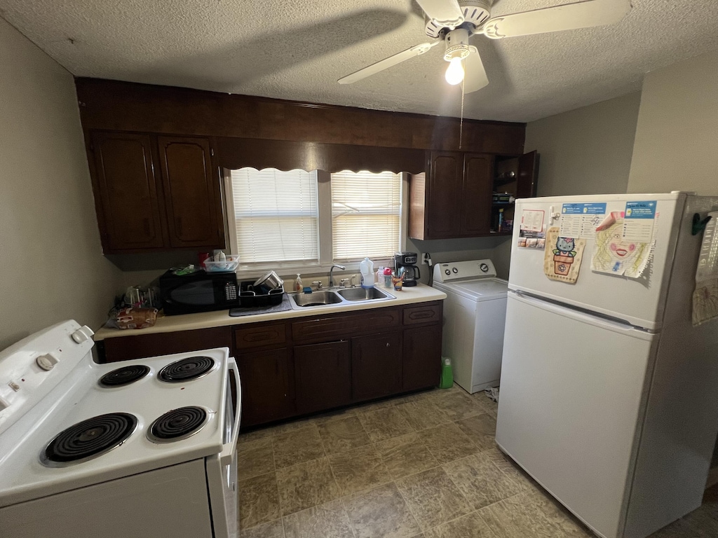304 Walnut Ave, South Pittsburg, TN 37380 - kitchen with white appliances, washer / dryer, light countertops, dark brown cabinets, and a textured ceiling