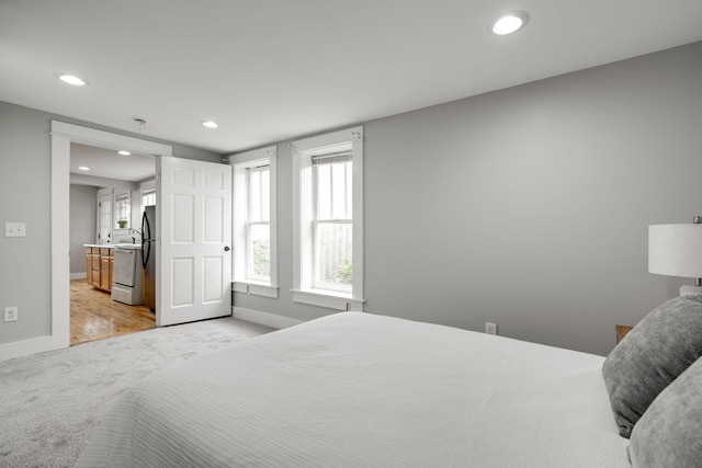 bedroom featuring light colored carpet