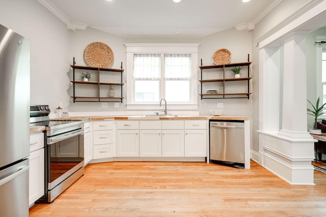 kitchen featuring white cabinets, stainless steel appliances, sink, and light hardwood / wood-style flooring