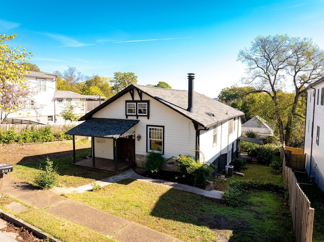 view of front of home with a front yard and central AC