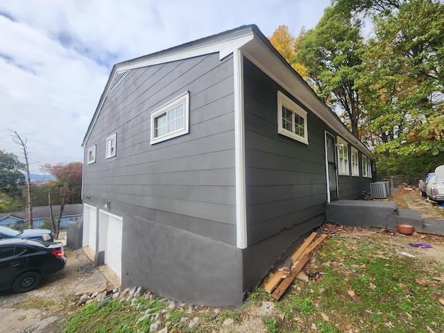 view of side of property with central air condition unit