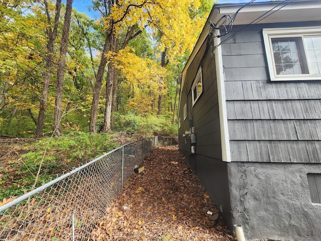 view of home's exterior featuring fence