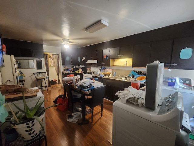 home office featuring washer / clothes dryer, ceiling fan, and wood finished floors