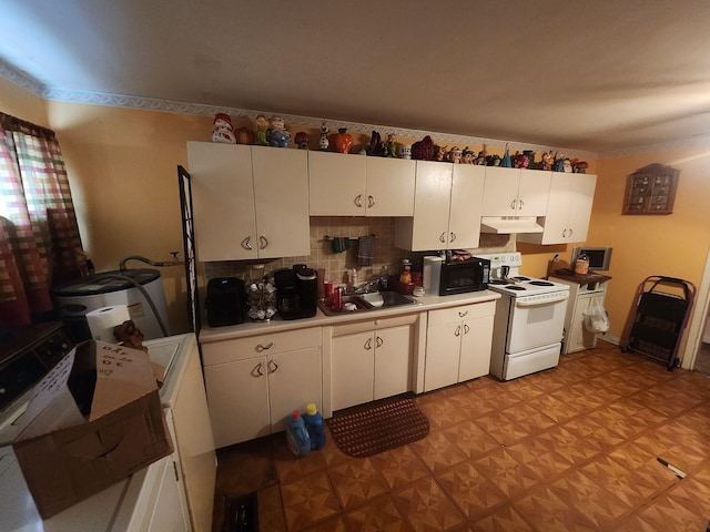 kitchen featuring white electric range oven, black microwave, under cabinet range hood, white cabinetry, and a sink