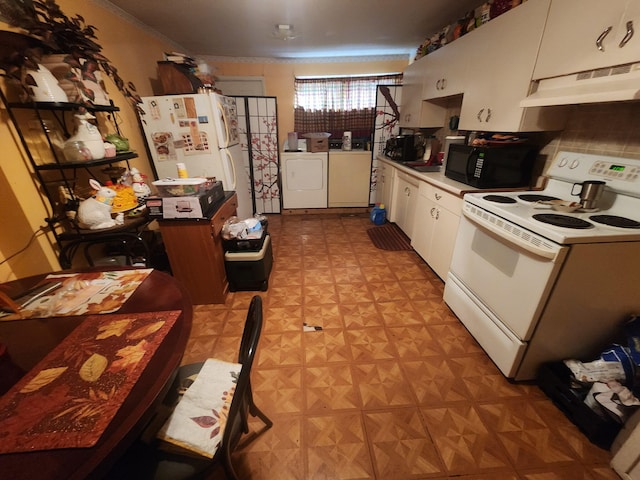 kitchen featuring white appliances, light floors, washer and dryer, under cabinet range hood, and white cabinetry