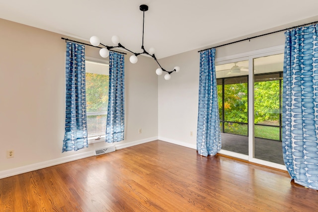 unfurnished dining area featuring hardwood / wood-style flooring and a healthy amount of sunlight