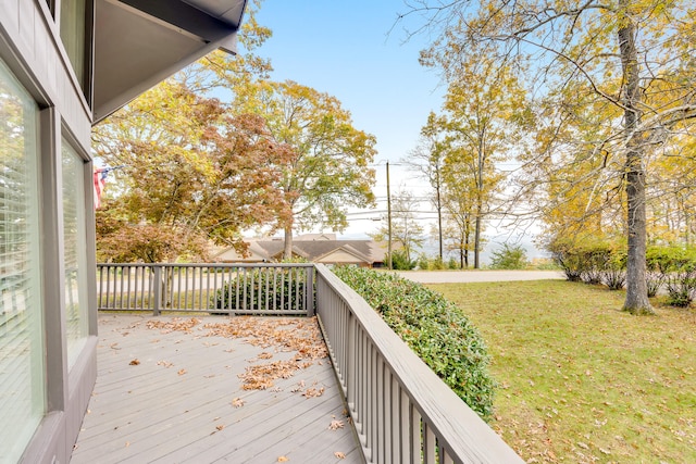 wooden deck featuring a lawn